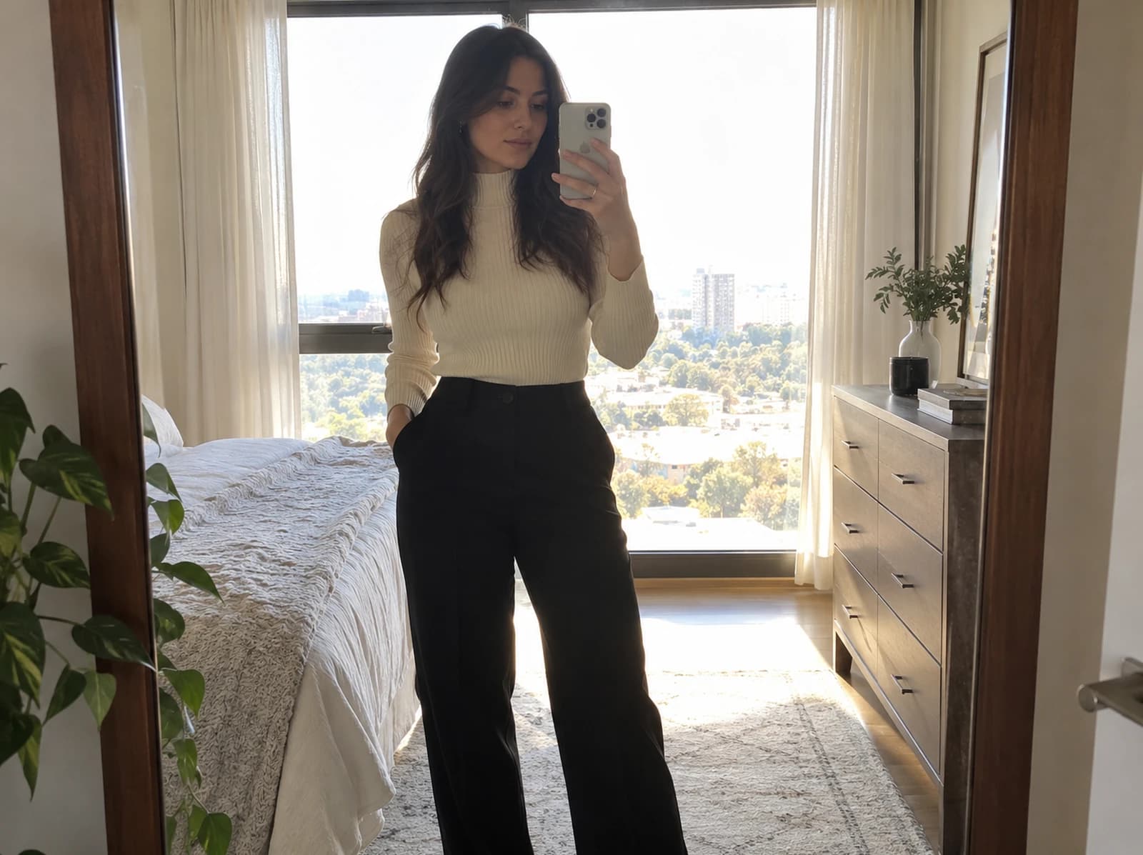 Mirror selfie with a bright window behind the subject